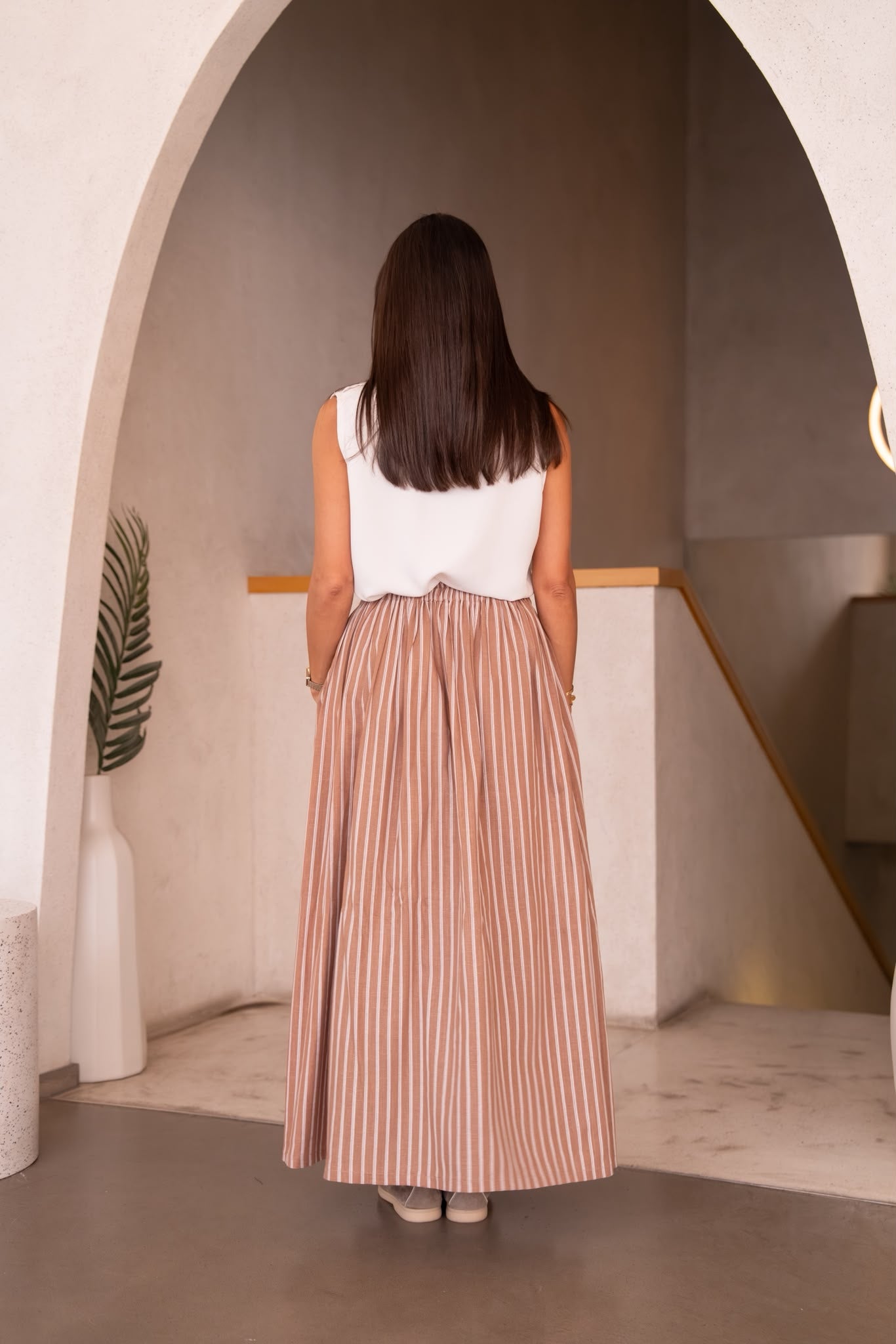 A white blouse and skirt set.C:251