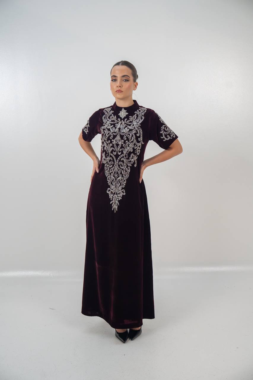 A distinctive burgundy velvet dress with hand embellishment. C:225