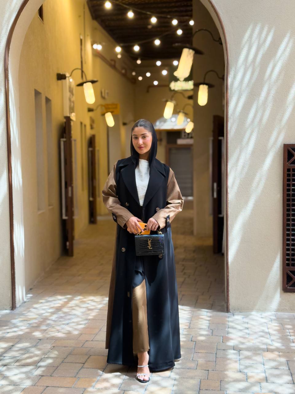 Black crepe blazer abaya in the front and a camel-colored trench coat in the back. C:6681