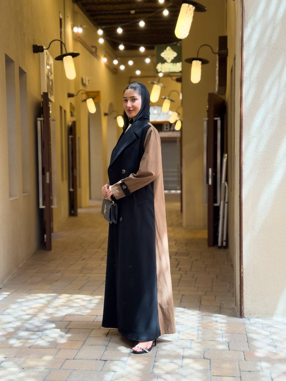 Black crepe blazer abaya in the front and a camel-colored trench coat in the back. C:6681