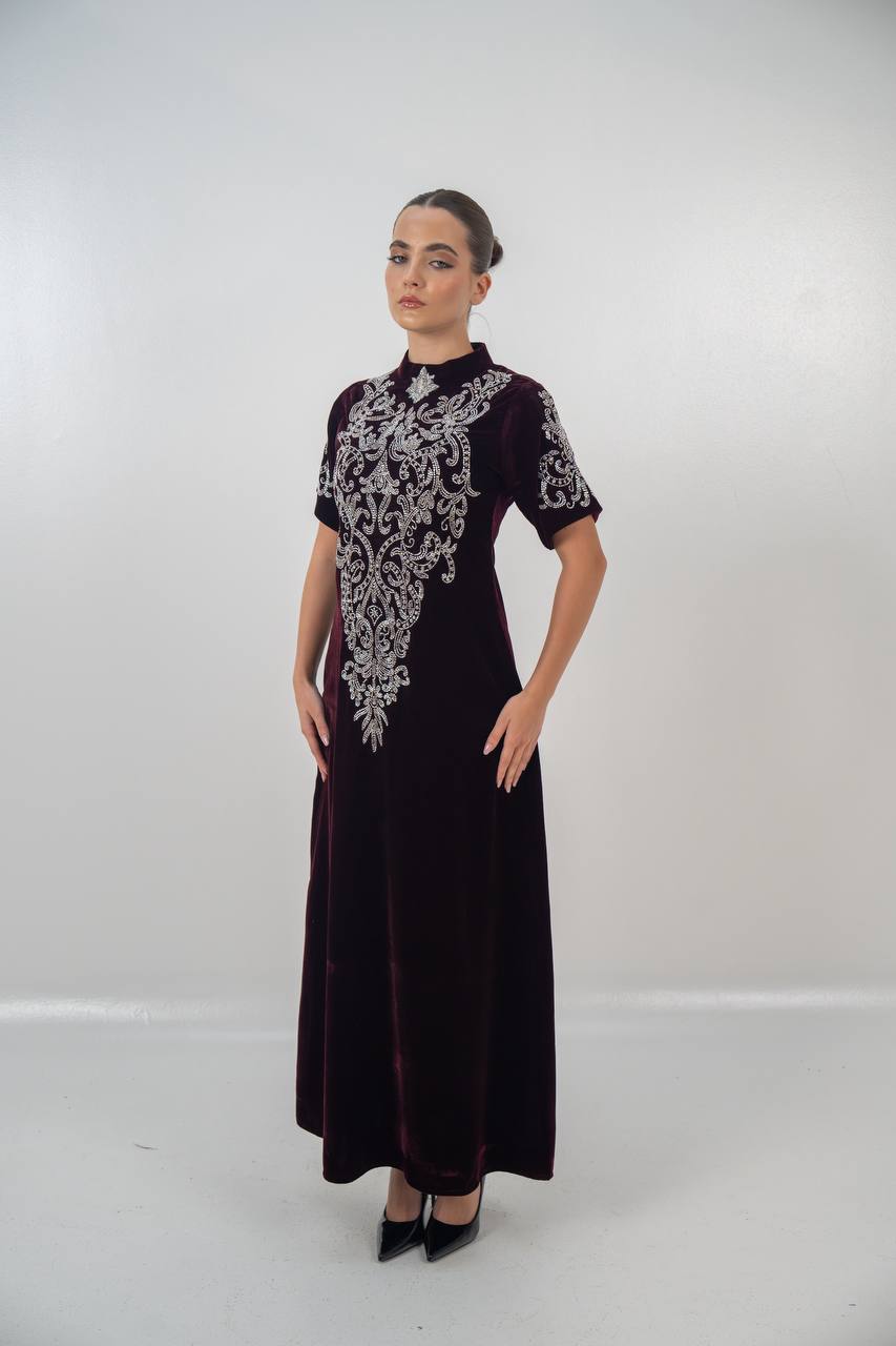 A distinctive burgundy velvet dress with hand embellishment. C:225